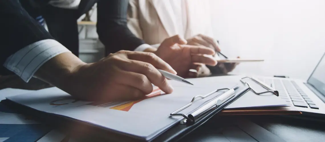 Valuer examining property documents for a retrospective valuation in Darwin